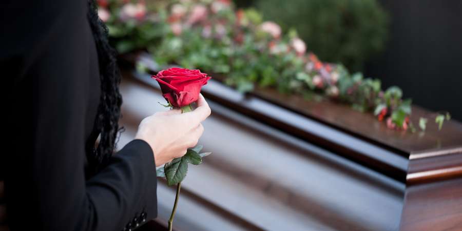 Rose and flowers on a coffin at a funeral